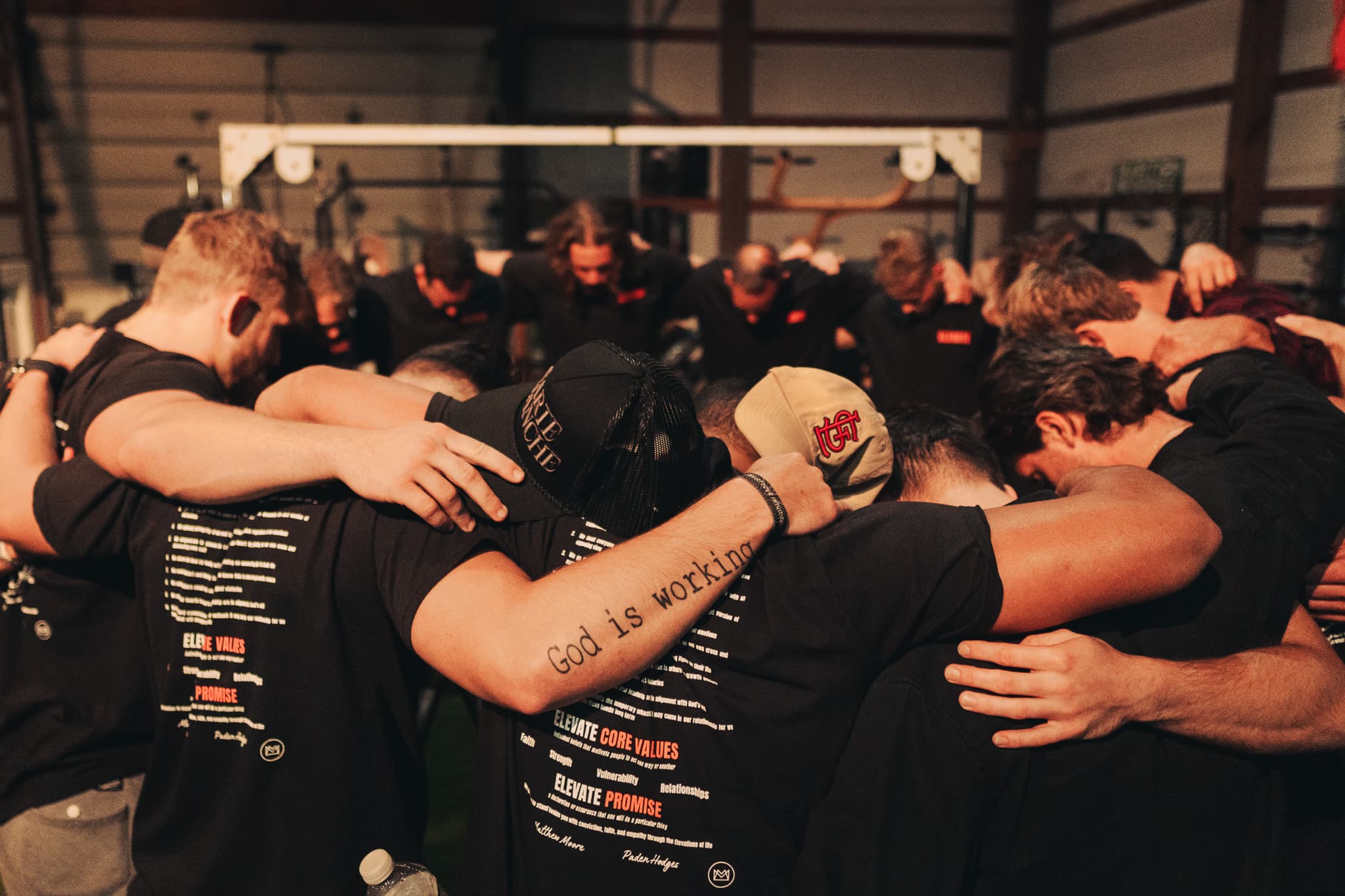 Elevate men in group prayer