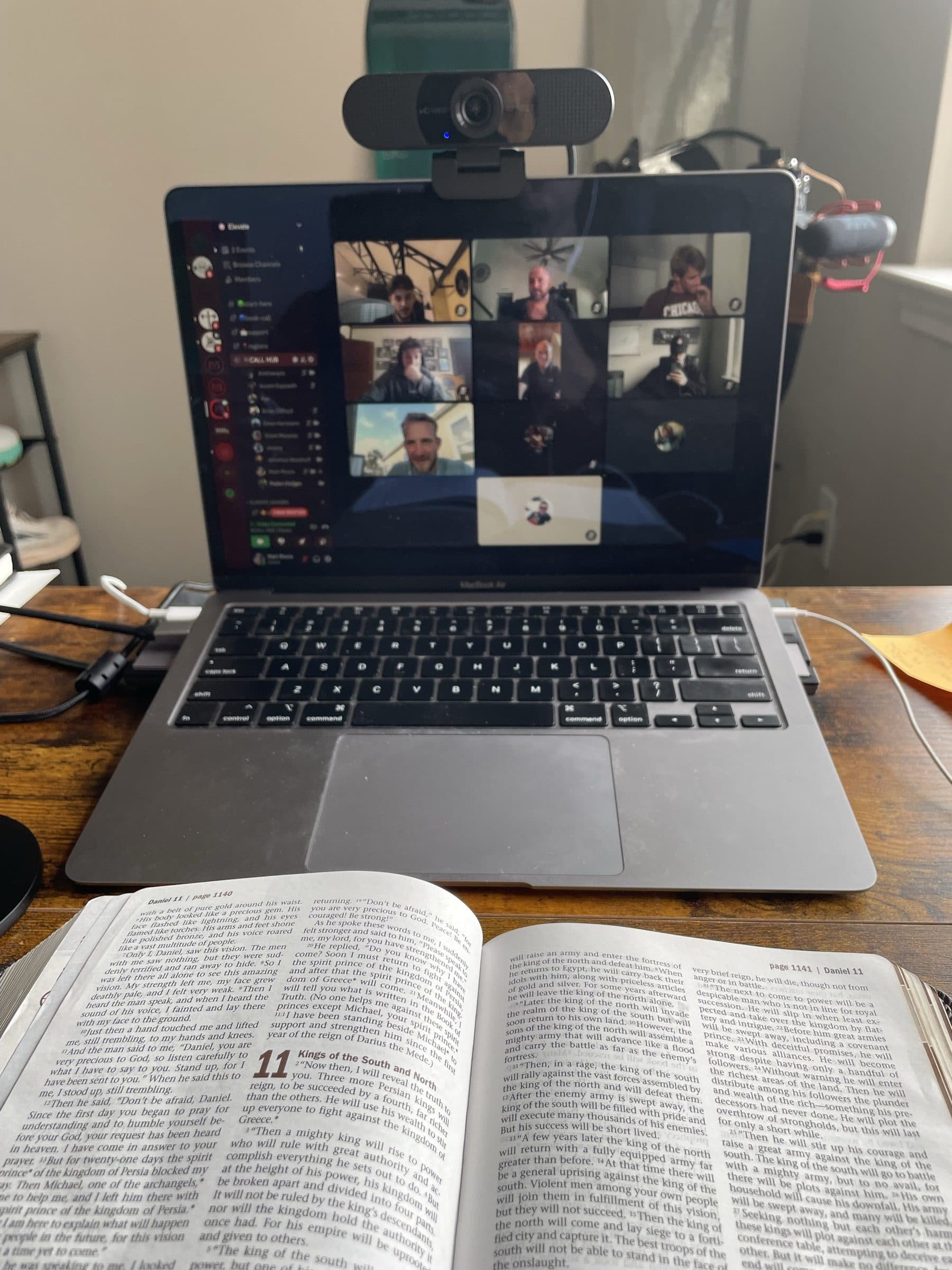 A virtual Elevate Bible study on a laptop with an open Bible beside it