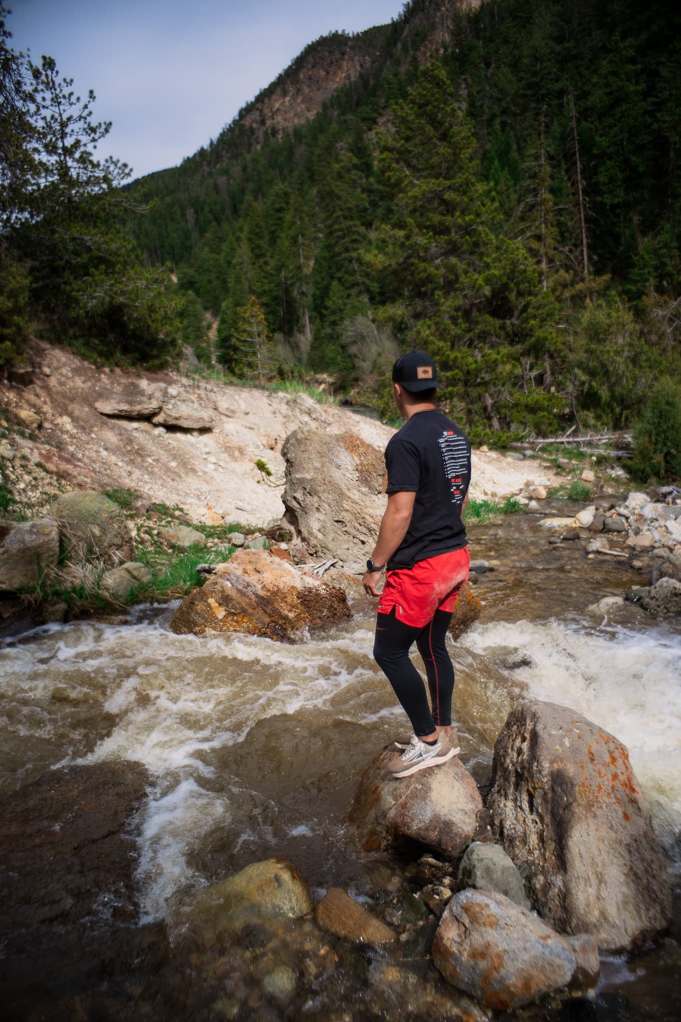 Standing on river rocks in the mountains